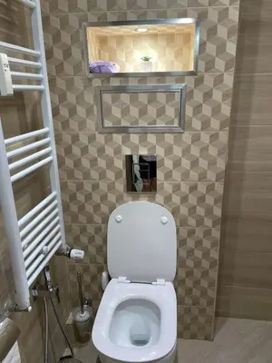 a bathroom with a white toilet in a room at Emlex Stylish Apartment in the Heart of Sofia in Sofia