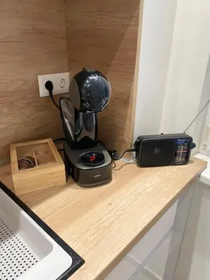 a black mixer sitting on a wooden counter top at Emlex Stylish Apartment in the Heart of Sofia in Sofia