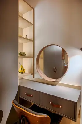 a dressing room with a mirror and a wooden chair at Luxury and stylish apartment in the heart of the city in Sofia