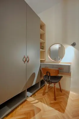 a dressing room with a chair and a mirror at Luxury and stylish apartment in the heart of the city in Sofia