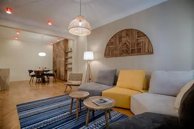 a living room with a couch and a table at Luxury and stylish apartment in the heart of the city in Sofia