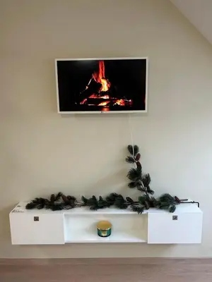 a white shelf with a tv on a wall at Zlati`s house 1 in Sofia