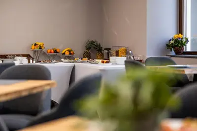a room with tables and chairs with food on them at Acacia Hotel in Sofia