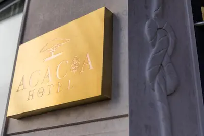 a sign for a hotel on the side of a building at Acacia Hotel in Sofia