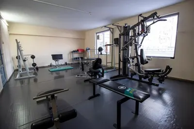 a gym with cardio equipment in a room with a window at ATM Hotel in Sofia