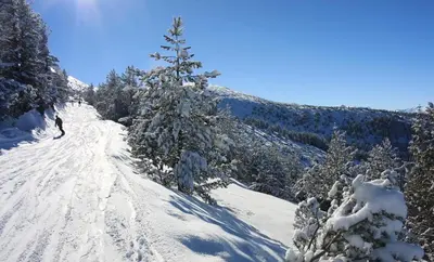 a person is skiing down a snow covered trail at Private large apartment in Iglika 2 for 4 people in Borovets