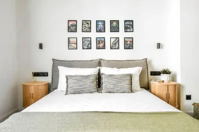 a bedroom with a bed with four pictures on the wall at Lift - Duplex - King Beds - 5min to Vitosha in Sofia
