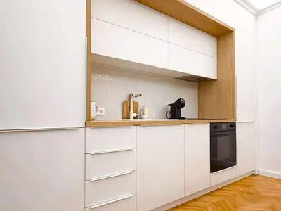 a kitchen with white cabinets and a sink at Lift - Duplex - King Beds - 5min to Vitosha in Sofia