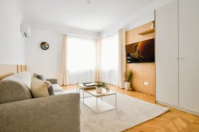 a living room with a couch and a table at Lift - Duplex - King Beds - 5min to Vitosha in Sofia