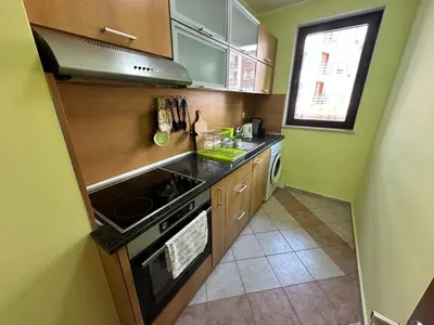 a small kitchen with a stove and a sink at Winslow Highland escape apartment in Bansko
