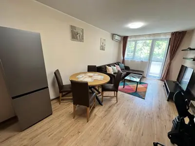a living room with a table and a couch at Winslow Highland escape apartment in Bansko