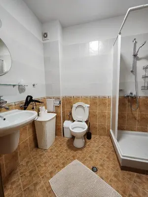 a bathroom with a toilet and a sink and a shower at Mountain Dream apartment near ski road in Bansko
