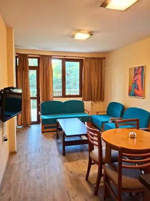 a living room with a couch and a table at Margarita Mountain Apartments in Tsigov Chark