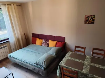 a bedroom with a bed and a table and a window at Apartment E45 in Borovets Gardens, Borovets resort in Borovets