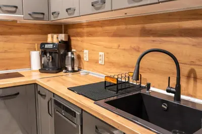 a kitchen with a sink and a counter top at All Seasons Plovdiv - Fast Wi-Fi, AC, Balconies in Plovdiv