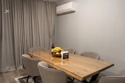a dining room table with a bowl of bananas on it at All Seasons Plovdiv - Fast Wi-Fi, AC, Balconies in Plovdiv