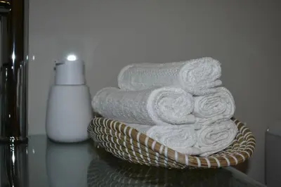 a stack of towels in a basket on a counter at The Corner apartments in Sofia