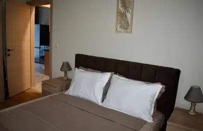 a bed with white pillows in a bedroom at The Corner apartments in Sofia