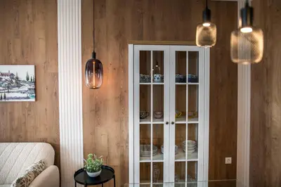 a room with a cabinet with dishes in it at ARHEYA 2 apart АРХЕЯ 2 апартамент за гости in Karlovo