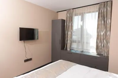 a bedroom with a bed and a television on the wall at Apartment Maritsa View 2 in Plovdiv