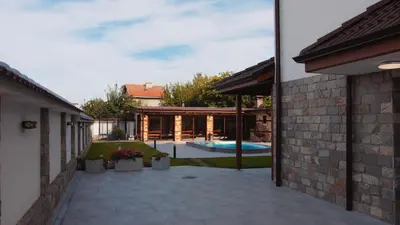 a backyard with a swimming pool and a house at Къща за гости Станковата къща in Belchin