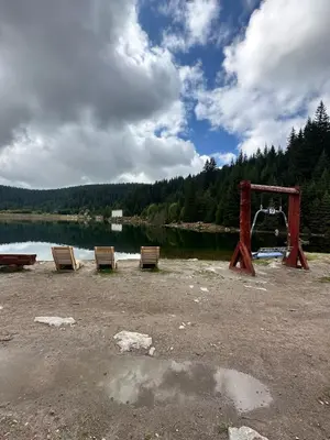 a group of chairs sitting next to a body of water at Апартаменты Гранд Ризорт с камином и видом на лес in Pamporovo
