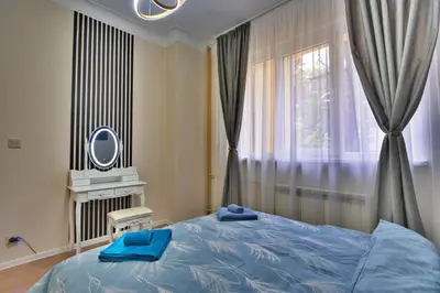 a bedroom with a blue bed and a window at The Heart of Sofia just steps away from Vitoshka in Sofia
