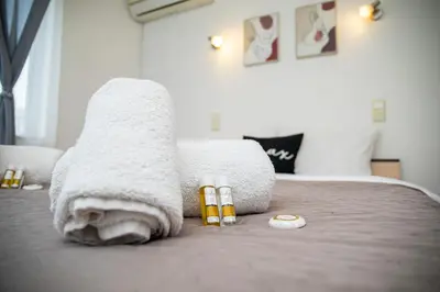 a bed with towels and medicines on top of it at Central Sofia Apartment & FREE Underground Garage in Sofia