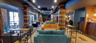 a living room with couches and chairs in a store at Charming Apartment Borovets Gardens D16 in Samokov