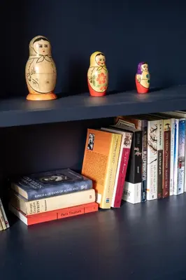 a book shelf with books and little owls on them at Retro-Chic 1BR Apartment next to Vasil Levski Blvd by Flat Mаnager in Sofia