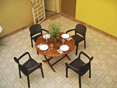 a wooden table with chairs and a tableasteryasteryasteryasteryasteryasteryasteryastery at Maritsa River Apartment in Plovdiv
