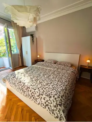 a bedroom with a bed with a black and white comforter at Serenity Lodge, close to NDK! in Sofia