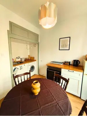 a kitchen with a table with a yellow vase on it at Serenity Lodge, close to NDK! in Sofia