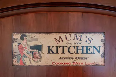 a sign for a kitchen on a wooden wall at Villa TIANA Bansko 7-Bedroom Luxury Chalet in Bansko