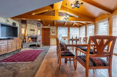 a dining room with a table and a fireplace at Villa TIANA Bansko 7-Bedroom Luxury Chalet in Bansko