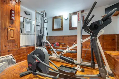 a room with a gym with exercise equipment on the floor at Villa TIANA Bansko 7-Bedroom Luxury Chalet in Bansko