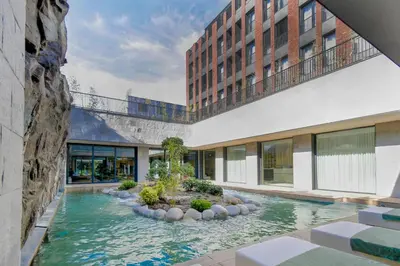 a swimming pool in the middle of a building at Hotel HAYASHI - Free Parking and Fitness in Sofia