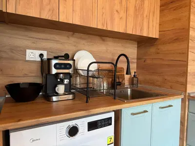 a kitchen with a sink and a counter top at SkyWay by NightSpace- Modern City Apartment in Sofia