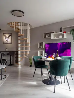 a dining room with a table and green chairs at Modern Vitosha View Apartment with Free Parking in Sofia
