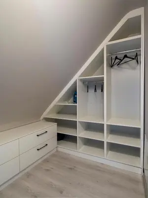 an attic room with white shelves and stairs at Modern Vitosha View Apartment with Free Parking in Sofia