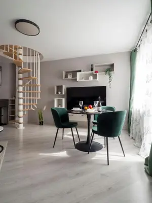 a living room with a dining room table and chairs at Modern Vitosha View Apartment with Free Parking in Sofia