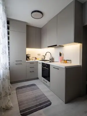a kitchen with white cabinets and a sink at Modern Vitosha View Apartment with Free Parking in Sofia