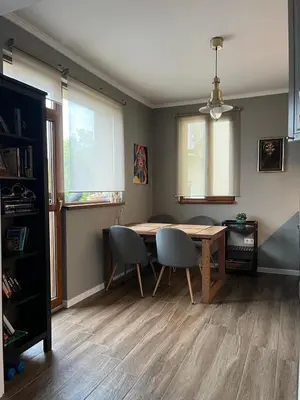 a dining room table and chairs in a room at Kate House in Sofia