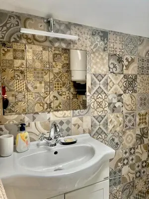 a bathroom with a white sink and a mirror at Kate House in Sofia