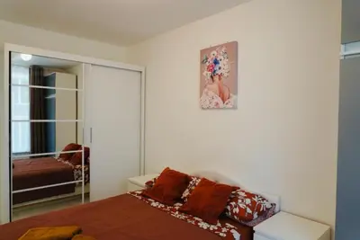 a bedroom with a bed and a picture on the wall at Top Central Apartment 14 in Sofia