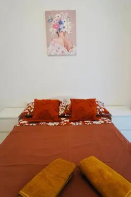 a bed with two pillows and a picture on the wall at Top Central Apartment 14 in Sofia