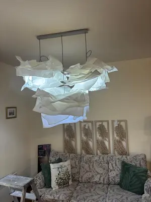 a chandelier with papers hanging over a couch at Emily Pirin Golf in Razlog