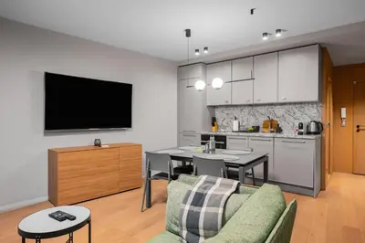 a living room with a kitchen and a dining room at Cozy Apartment in Lozenetz by 7th Sence in Sofia