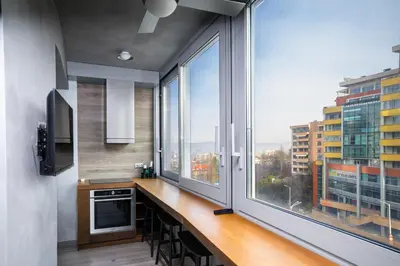 a kitchen with a large window with a view of a city at Cozy Apartment in Lozenetz by 7th Sence in Sofia