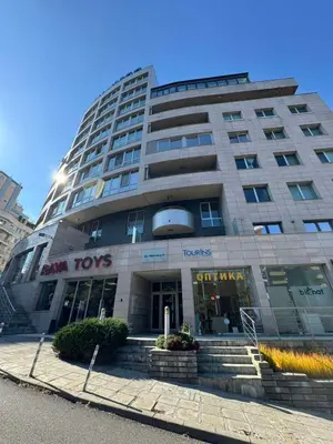 a large building with stairs in front of it at Cozy Apartment in Lozenetz by 7th Sence in Sofia